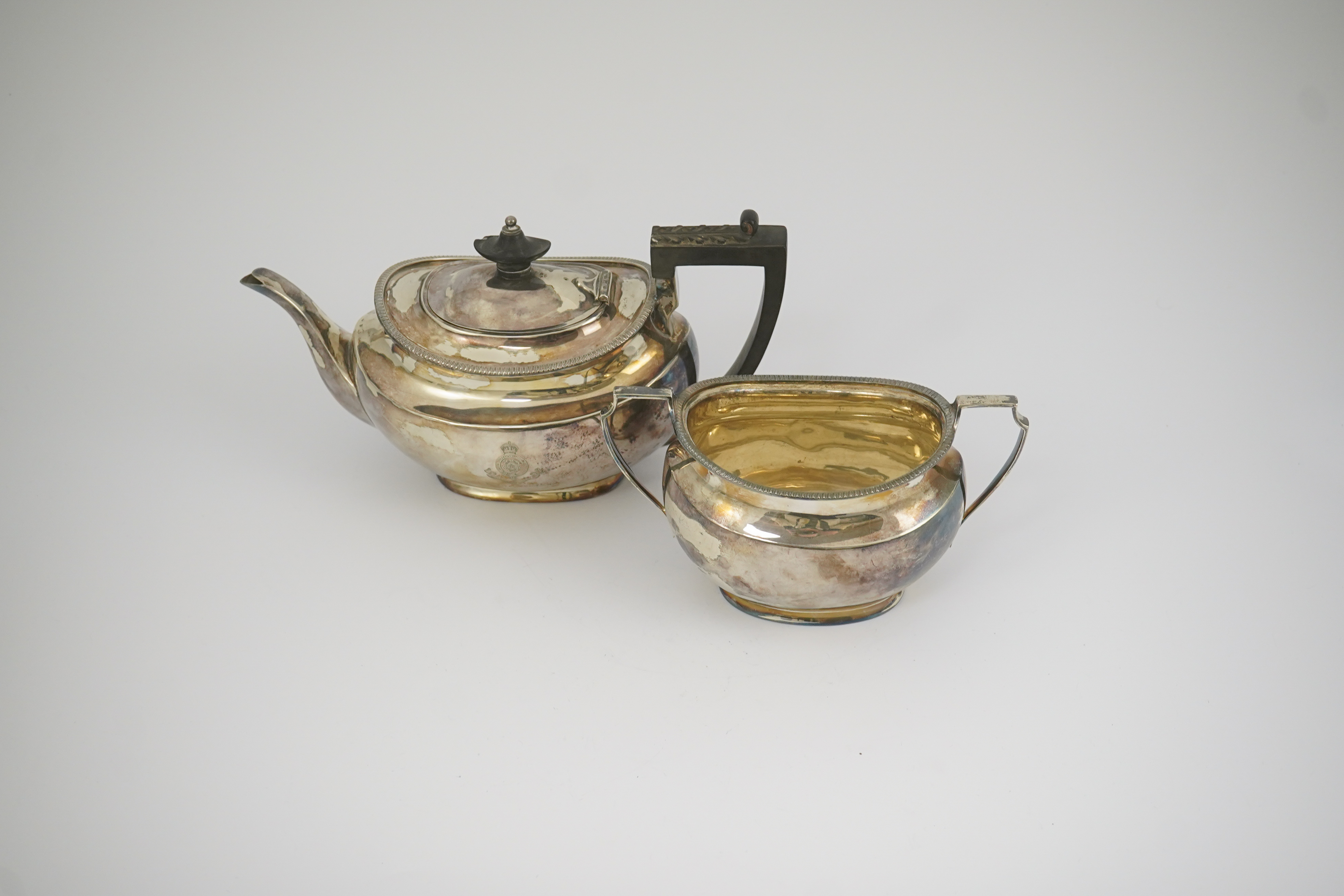 An Edwardian silver teapot and a matching sugar bowl, with engraved inscription, relating to the Royal Fusiliers, by Atkin Brothers